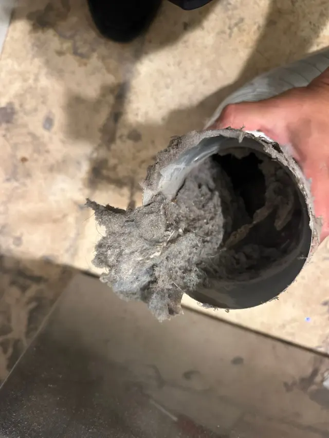 Dryer vent pipe with a thick plug of lint at its opening