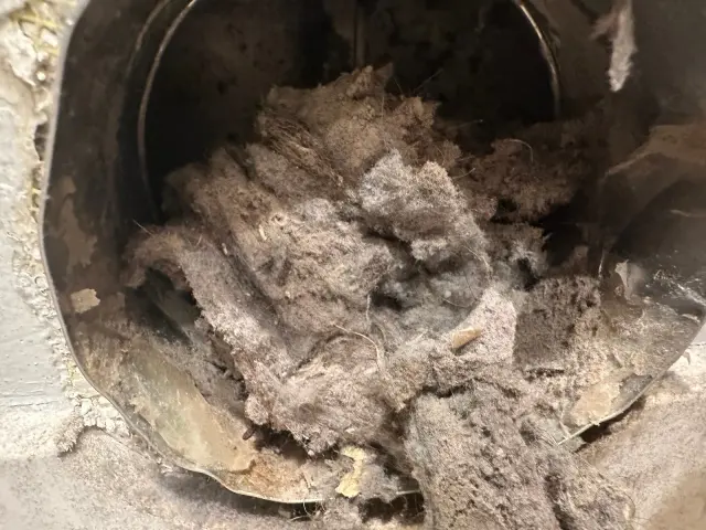 Lint packed inside a metal dryer vent duct