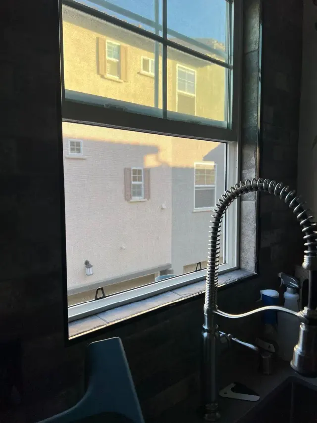 Kitchen window above the sink with a window screen